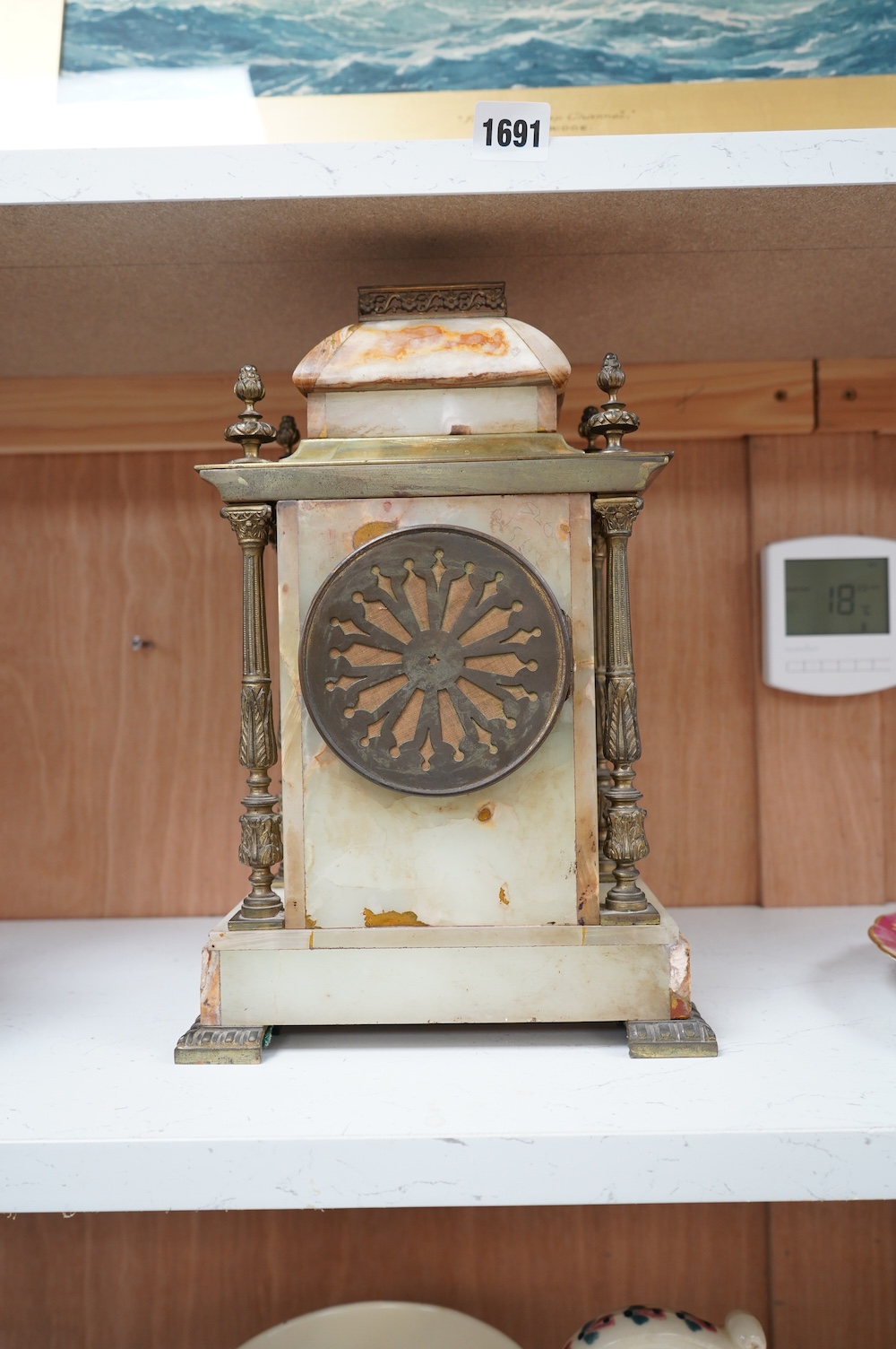 An early 20th century marble and onyx mantel clock with enamel dial with pendulum, no key, 32cm high. Condition - fair, untested